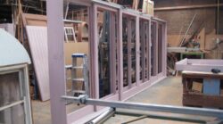 Custom solid timber door frames being assembled and clamped in the Marrickville Joinery workshop, demonstrating precision manufacturing of bespoke door components.