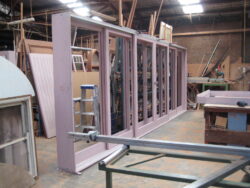 Custom solid timber door frames being assembled and clamped in the Marrickville Joinery workshop, demonstrating precision manufacturing of bespoke door components.