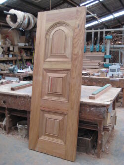 Custom arched multi-panel timber door featuring a semicircular arched top and traditional raised panel design, crafted by Marrickville Joinery for heritage and classic architectural applications.