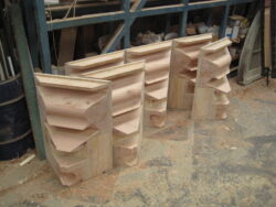 Ornate hand-carved timber corbels featuring traditional scrollwork and decorative detailing, crafted by Marrickville Joinery for architectural and heritage applications. Decorative Carved Timber Corbels