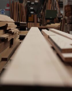 Custom timber molding profiles and elements stacked in the Marrickville Joinery workshop, showing the variety of joinery components produced. Timber Molding Profiles in Workshop