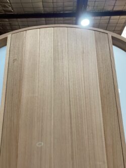 Workshop view of a natural blonde timber door showing panel construction and joinery detail, in production at Marrickville Joinery.