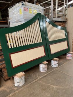 Custom green-painted timber gate featuring horizontal slat panels and vertical post framing, handcrafted at the Marrickville Joinery workshop.