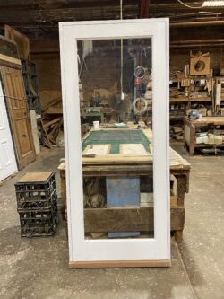Marrickville Joinery workshop bench showing custom timber door components and framing elements during production.