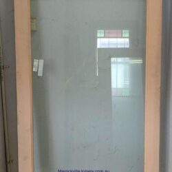 Frosted glass panel set within a timber door frame, providing privacy while allowing light to pass through.