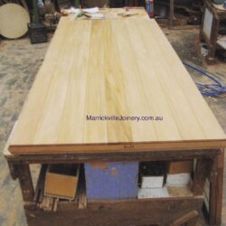 Long rectangular solid timber benchtop or dining table in a natural pale timber finish, handcrafted in the Marrickville Joinery workshop. Solid Timber Benchtop