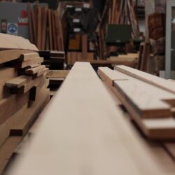 Stack of raw timber boards and planks stored in the Marrickville Joinery workshop, ready for processing. Raw Timber Boards in Workshop