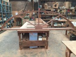 Large decorative heritage arch structure under construction in the workshop, showing the scale and complexity of heritage restoration work. Heritage Arch Frame Under Construction