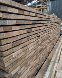 Timber planks and boards neatly stored on shelving racks within the Marrickville Joinery workshop. Timber Plank Storage
