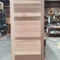 A simple flat-panel door finished in primer, ready for painting and installation.