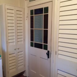 Heritage-style solid timber door featuring slatted louvre panels in the lower section.