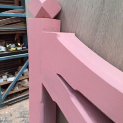 Pink painted decorative architectural pediment or arch crown detail, handcrafted for heritage building restoration. Pink Arch Pediment Detail