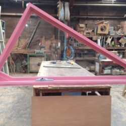 Pink painted timber gate frame sections with decorative X-cross diagonal bracing, ready for assembly. X-Cross Braced Gate Frame Sections