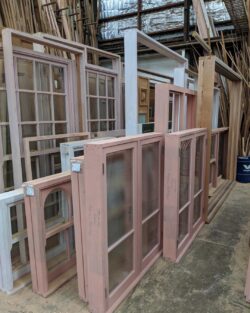 Multiple heritage doors and window frames stored in the Marrickville Joinery workshop, representing the breadth of the joinery's output. Heritage Joinery Workshop Collection