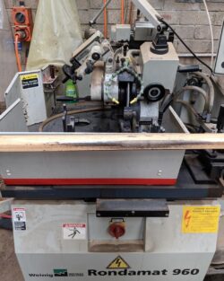 Industrial woodworking panel saw machine in operation, used for precision cutting of large timber sheets.
