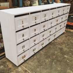 Bank of 25+ numbered white-painted timber apartment letterboxes, custom-built for a residential apartment complex. Numbered Apartment Letterbox Bank