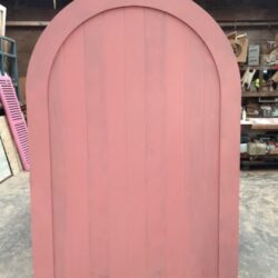 Pink painted heritage door with a curved arched top and decorative panel moulding, suited to Federation-era homes.