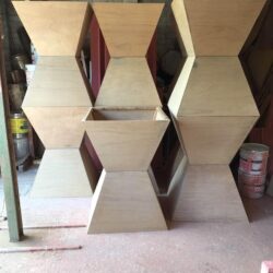 Angular geometric diamond-shaped timber pieces arranged decoratively, likely architectural inlays or feature panels cut on the CNC router. Geometric Timber Diamond Shapes
