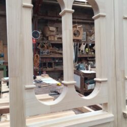 Ornate heritage entrance doorway surround being constructed, featuring classical columns/pilasters and a decorative arch with entablature detail.