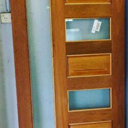 Contemporary flush timber door featuring three horizontal frosted glass inserts, shown in natural timber finish.