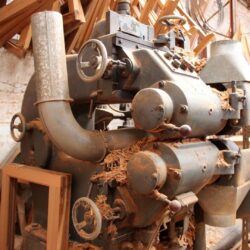 Old cast iron workshop machinery components, showing vintage mechanical equipment used in heritage joinery production.
