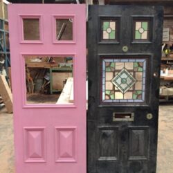 Pink painted heritage panel door featuring decorative leadlight stained glass inserts within the door panels.