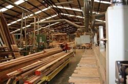 Wide view of the Marrickville Joinery workshop interior, showing the large workspace with stacked timber and processing equipment.