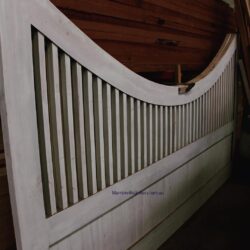 Curved or arched balustrade section showing the flowing profile of a heritage staircase railing, demonstrating expert bending and shaping.