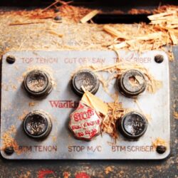 Close-up of old industrial machinery controls showing multiple switches and levers, part of the vintage joinery equipment at Marrickville Joinery.