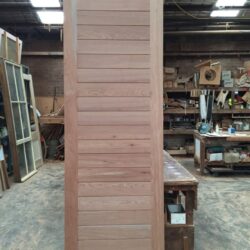 Timber louvred panels or shutters in the workshop, showing heritage-style ventilation screens for windows and doors.