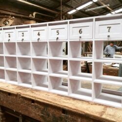 White painted shelving unit with numbered small pigeon-hole compartments, used for organised storage of hardware and fittings. Numbered White Pigeon-Hole Shelving