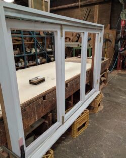 Multiple timber door and window frames leaning or stored in the workshop, showing production in progress at Marrickville Joinery.