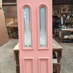 Heritage door featuring two tall narrow vertical oval glass inserts, an elegant decorative glazing design for period homes.