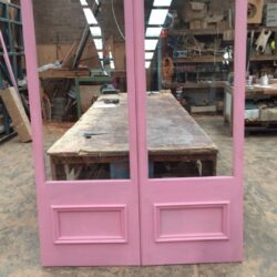 Simple pink painted four-panel heritage door showing a clean traditional design for period home restoration.