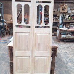 Elegant white painted double door featuring arched oval glazing panels, combining classical form with decorative glass.