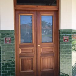 Ornate heritage entrance featuring double doors with leadlight glass, set within a tiled vestibule surround — a classic Federation-era design.