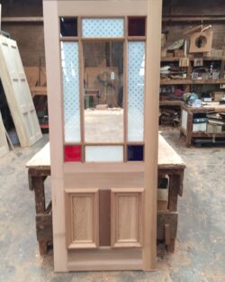 Heritage door featuring a narrow panel of coloured or tinted art glass as a decorative insert, adding character to a traditional door design.