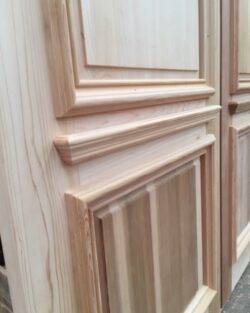 Heritage door frame featuring a classical ornate pediment and entablature above, showing decorative heritage entrance joinery craftsmanship.