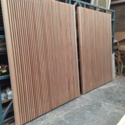 Close-up of vertical board and batten or tongue-and-groove timber panelling, showing heritage-style wall or door cladding.