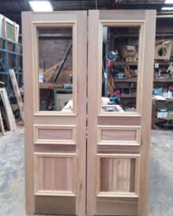 Tall slender heritage door featuring narrow frosted glass inserts along the sides, combining elegance with privacy.