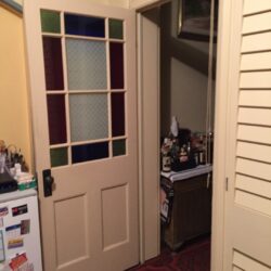 Heritage door featuring coloured art glass strip panels arranged vertically, adding decorative colour to a traditional door design.