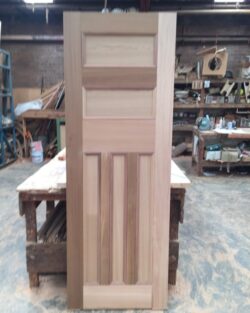 Traditional four-panel raised panel door in natural timber finish, a classic heritage door design suitable for period residential use.