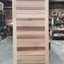 A decorative timber stair stringer or furniture component showing profiled moulding and traditional joinery craftsmanship.
