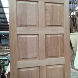 Plain natural timber heritage door with four raised panels, a timeless design for traditional Australian residential properties.